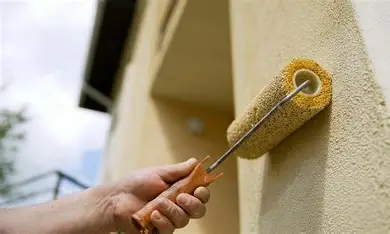 Using a roller to paint stucco