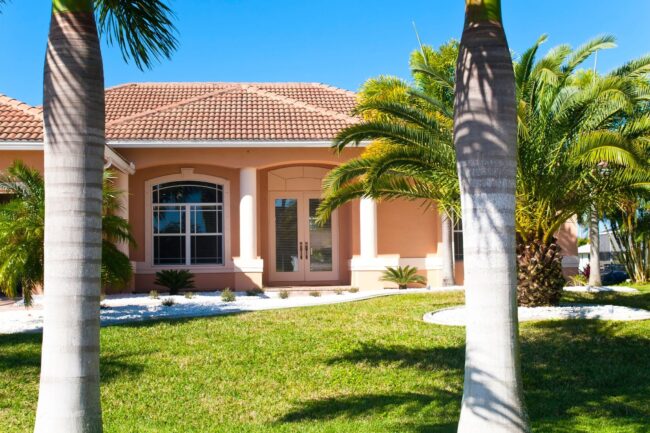 New upscale home in Florida, front yard with big palm trees. DIY home repair tips Southwest Florida